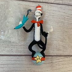 a cat in the hat figure sitting on top of a ball