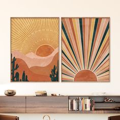 two paintings hanging on the wall above a table