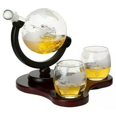 Globe Decanter with Ship Sculpture and 2 Globe Tumblers Embrace your sense of adventure, love of travel, and enjoyment of spirits with this stunning, hand-crafted, lead-free glass decanter. An artistically detailed antique ship is encased in the decanter, with an etched globe map on the glass and tumblers. Color: Clear. Whiskey Gift Set, Vodka Gifts, Wine Purse, Whiskey Set, Whiskey Decanter Set, Whiskey Lover Gifts, Whiskey Stones, Mahogany Stain, Good Whiskey