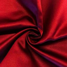 a red and purple fabric is shown in close up