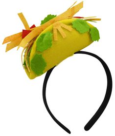 a yellow hat with green leaves and red bows on it's brimmed headband