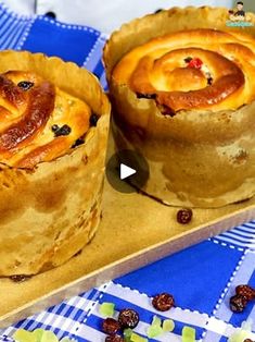 two pastries sitting on top of a wooden tray