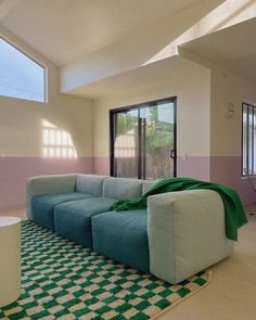 a living room filled with furniture and windows