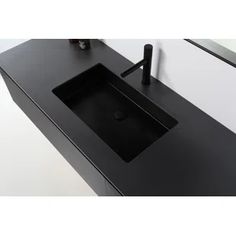 a black bathroom sink sitting under a mirror