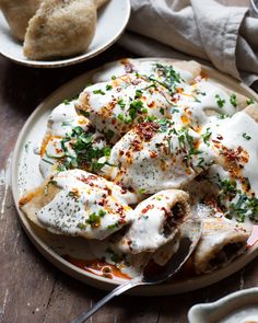 a white plate topped with chicken covered in sauce