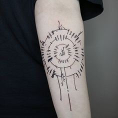 a person with a tattoo on their arm that has writing all over it and an arrow in the middle