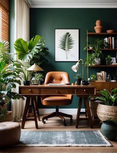 a home office with green walls and potted plants