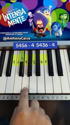 someone is playing the piano in front of an ad for disney and pixama