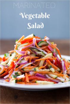 vegetable salad on a white plate with the words marinated vegetable salad in front of it