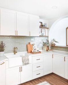 the kitchen is clean and ready for us to use it's white cabinetry