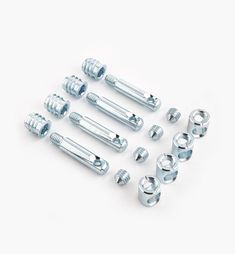 an assortment of screws and nuts on a white background