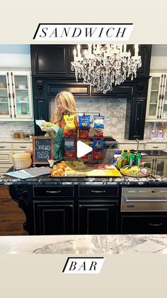 a woman standing in front of a kitchen counter with food on it and the words sandwich below her