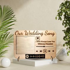 a wooden sign that says our wedding song