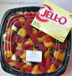 a package of jello sitting on top of a plastic container filled with candy fruit