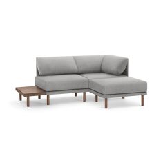 a gray couch with wooden legs and a coffee table in front of it on a white background