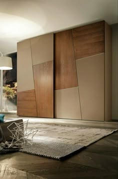 a living room filled with furniture next to a large wall mounted cabinet and floor lamp