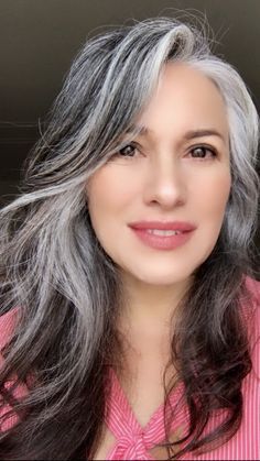 a woman with grey hair and pink shirt