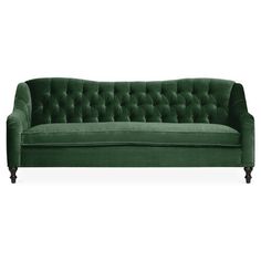 a green velvet couch with black legs and buttons on the back, sitting in front of a white background