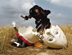 two models in costumes on the runway and an egg