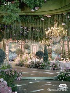 an elaborate garden with chandeliers, flowers and greenery is featured in this ad