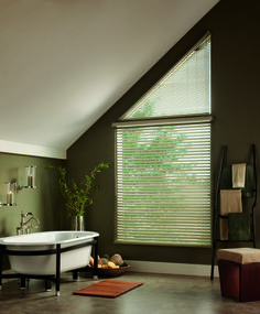 a bath tub sitting under a window in a bathroom