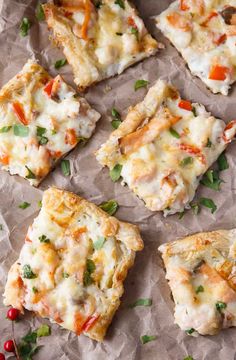 several pieces of pizza sitting on top of a piece of wax paper