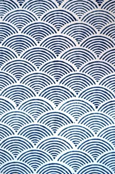 a blue and white wallpaper with wavy waves in the shape of an ocean wave