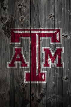 the texas a & m logo is painted on a wooden fence