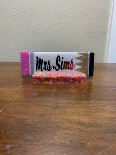 a candy bar sitting on top of a wooden table covered in sprinkles