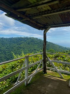 a wooden bench sitting on top of a lush green hillside