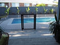 an empty swimming pool is seen through the glass doors