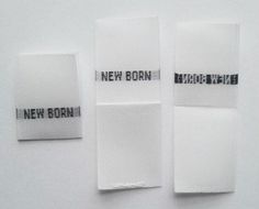 three pieces of white cloth with black words on them