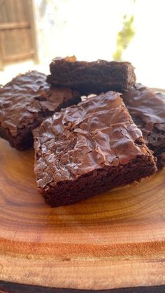 some brownies are sitting on a wooden plate