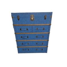 a blue chest with four drawers and brass hardware on the bottom, in front of a white background