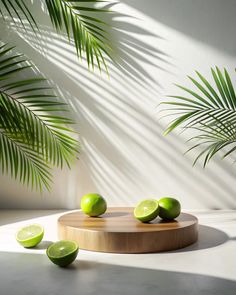 limes on a cutting board with palm leaves in the backgrounnd and sunlight coming through