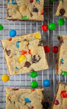 cookie bars with m & m and m's on the top are cooling on a rack