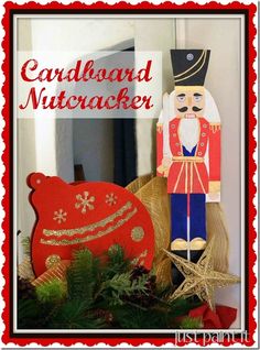 a wooden nutcracker sitting on top of a table next to a christmas decoration