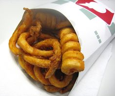 some onion rings are in a paper bag