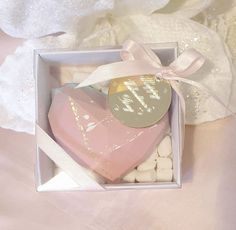 a pink heart shaped box filled with marshmallows