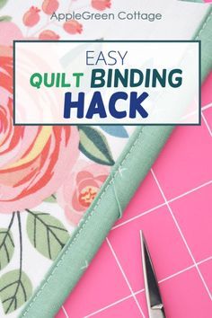 a pair of scissors sitting on top of a piece of fabric with the words easy quilt binding hack