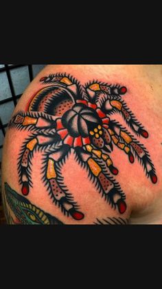 a man's arm with a spider tattoo on the back of his shoulder and chest