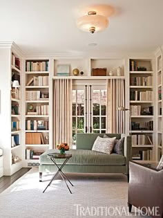 a living room with lots of bookshelves and furniture on the shelves in front of it