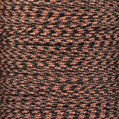 a spool of orange and black thread