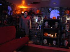 a living room filled with halloween decorations and creepy faces on the walls, including fake heads