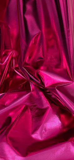 a close up view of shiny pink material that looks like metallic foil or plastic sheeting