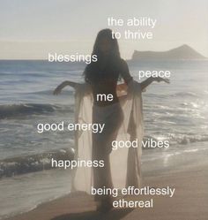 a woman standing on top of a beach next to the ocean with words above her