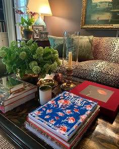 a living room filled with lots of furniture and books on top of a coffee table