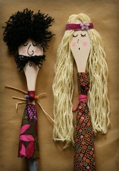 two dolls made to look like people with long hair and braids on their heads