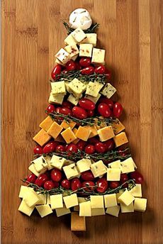 a christmas tree made out of cheese and tomatoes