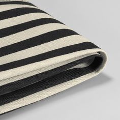 the black and white striped fabric is folded on top of each other, with stripes